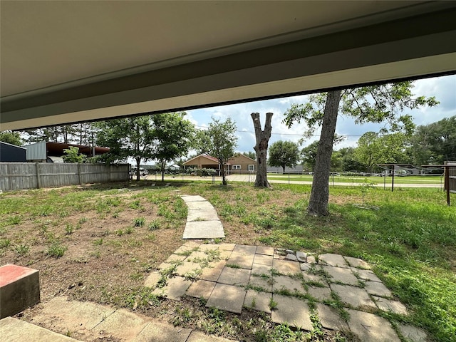 view of yard featuring fence and a patio