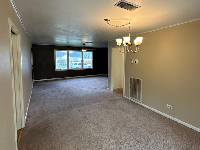 spare room with visible vents, a chandelier, carpet, and baseboards