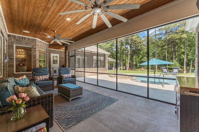 sunroom / solarium featuring a ceiling fan and outdoor lounge area