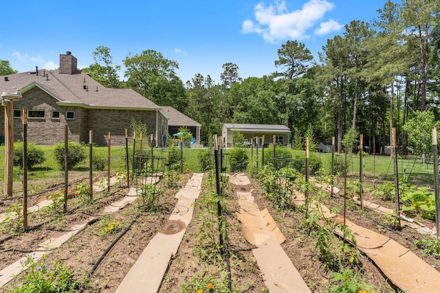 view of yard featuring fence and a vegetable garden