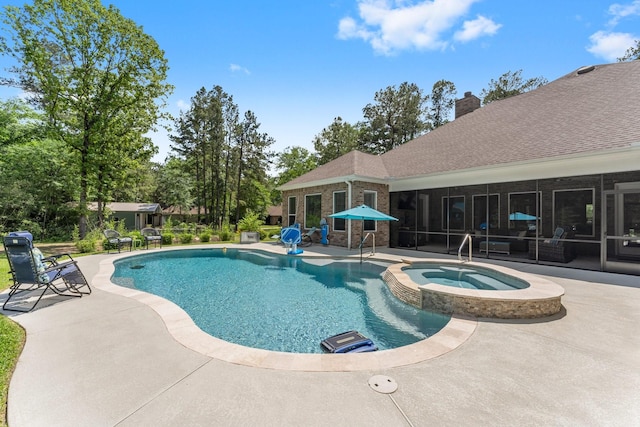 view of swimming pool with a patio, a pool with connected hot tub, and a sunroom
