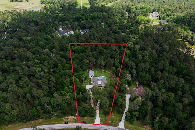 birds eye view of property with a view of trees