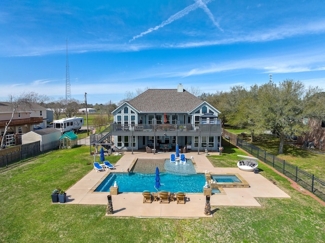 rear view of house featuring a deck, a yard, a fenced backyard, and a patio area