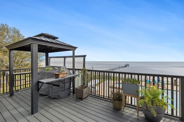 wooden terrace featuring a gazebo and a water view