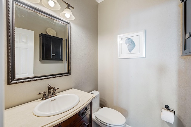 bathroom featuring toilet and vanity