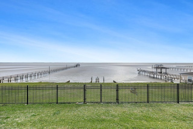 view of yard featuring fence and a water view