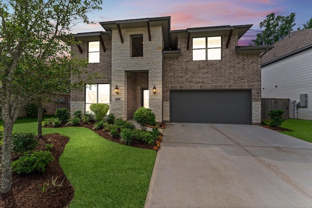 view of front of house featuring a garage, concrete driveway, brick siding, and stone siding