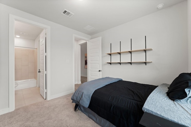 bedroom featuring visible vents, baseboards, ensuite bathroom, light colored carpet, and light tile patterned floors