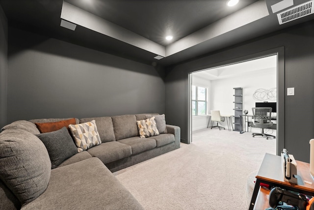 living area with a raised ceiling, recessed lighting, visible vents, and carpet