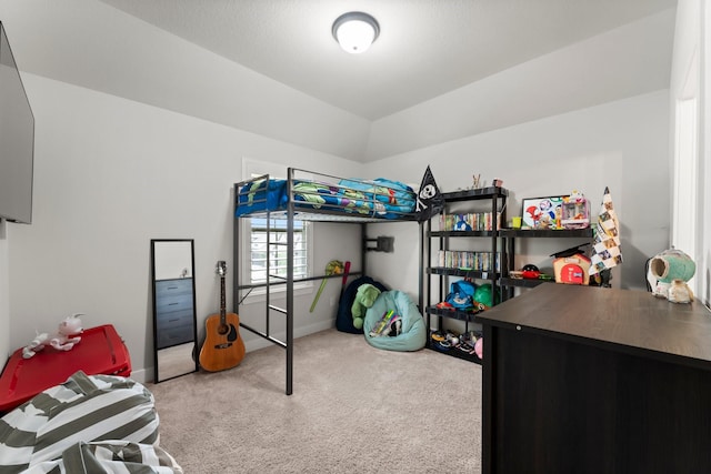 carpeted bedroom with baseboards and vaulted ceiling