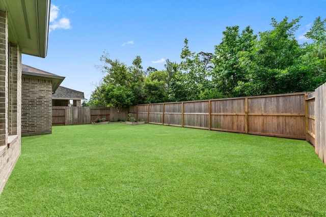 view of yard with a fenced backyard