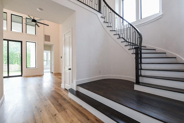 202 Calm Savanna Ct, Conroe, TX 77318 - entrance foyer with a high ceiling, ceiling fan, wood finished floors, stairway, and baseboards