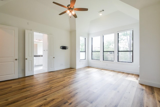 202 Calm Savanna Ct, Conroe, TX 77318 - empty room with healthy amount of natural light, a ceiling fan, wood finished floors, and high vaulted ceiling