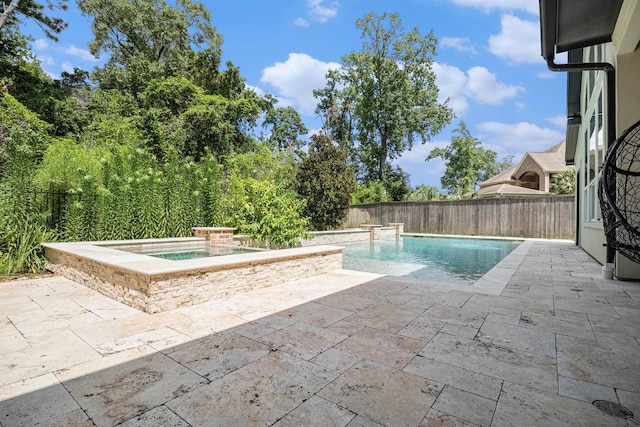 view of pool featuring a patio, a fenced backyard, and an in-ground hot tub