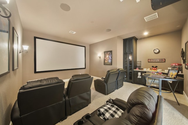 home theater room featuring light colored carpet