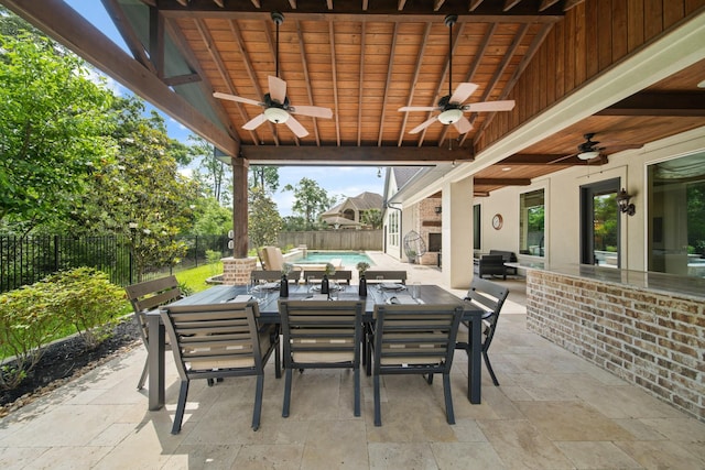 view of patio / terrace featuring outdoor dining space, a fenced backyard, and a ceiling fan