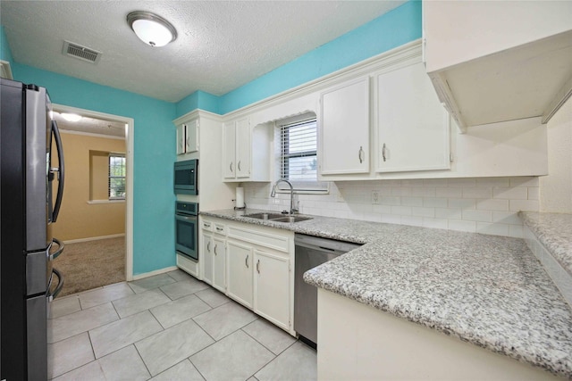 255 Shekel Ln, Houston, TX 77015 - kitchen featuring visible vents, a sink, white cabinetry, and stainless steel appliances