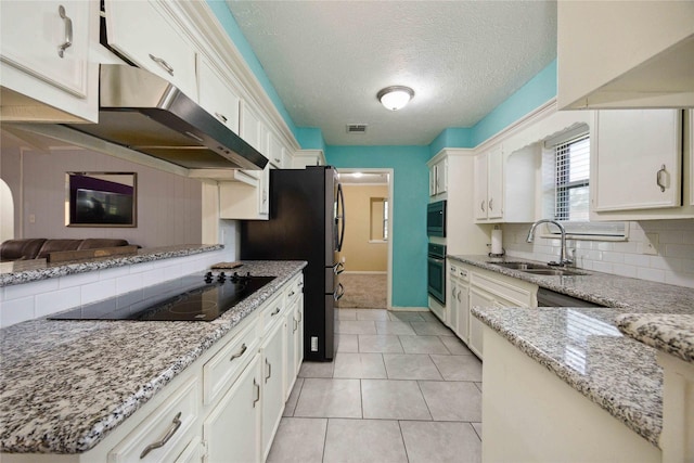 255 Shekel Ln, Houston, TX 77015 - kitchen featuring appliances with stainless steel finishes, a sink, white cabinetry, backsplash, and visible vents