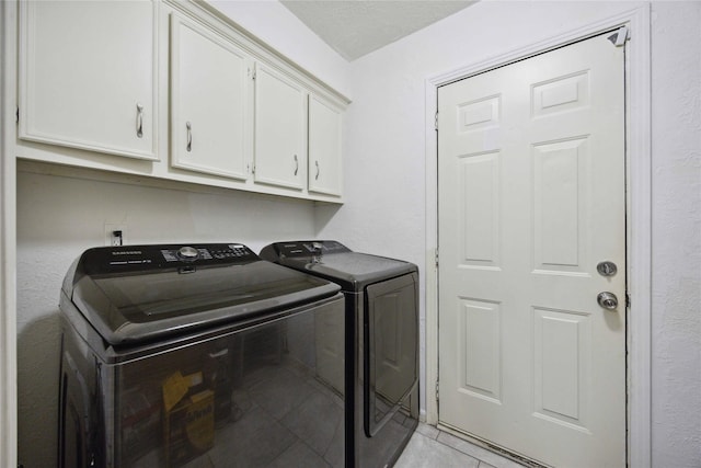 255 Shekel Ln, Houston, TX 77015 - washroom with light tile patterned flooring, cabinet space, and washing machine and clothes dryer