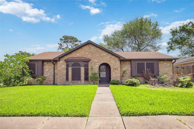 255 Shekel Ln, Houston, TX 77015 - view of front facade featuring brick siding, roof with shingles, and a front lawn