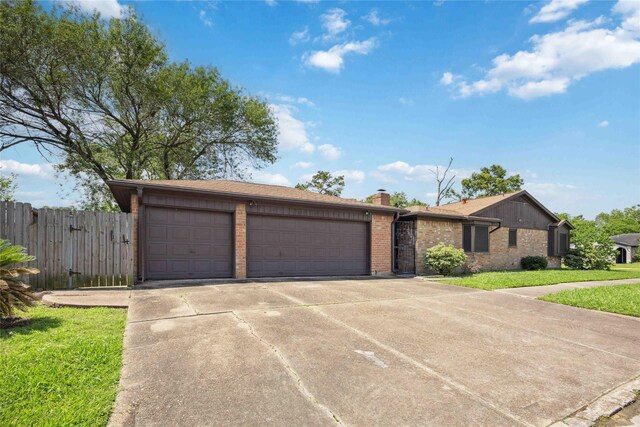 255 Shekel Ln, Houston, TX 77015 - single story home with fence, an attached garage, brick siding, a chimney, and driveway