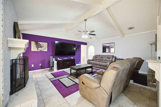 255 Shekel Ln, Houston, TX 77015 - living area featuring tile patterned flooring, a brick fireplace, lofted ceiling with beams, arched walkways, and a ceiling fan