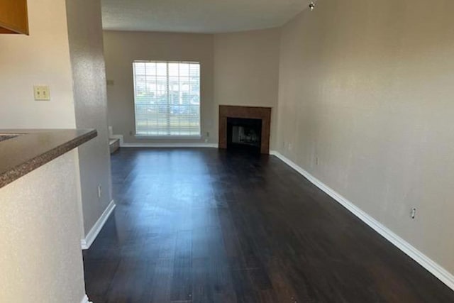 3600 Jeanetta St Unit 2502, Houston, TX 77063 - unfurnished living room with dark wood-type flooring and a fireplace