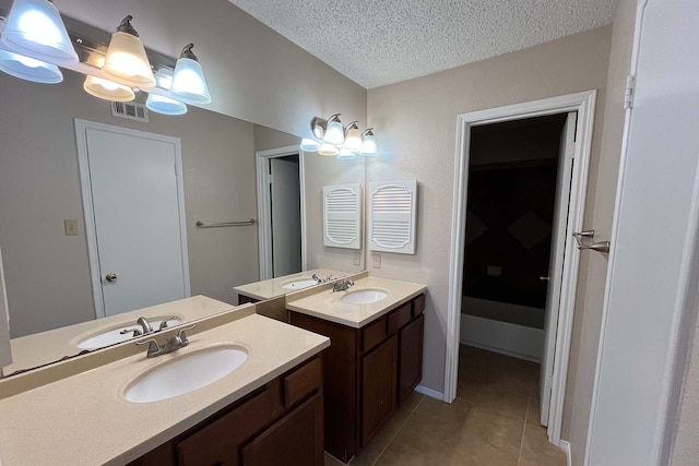 3600 Jeanetta St Unit 2502, Houston, TX 77063 - full bath featuring two vanities, a textured ceiling, and tile patterned flooring