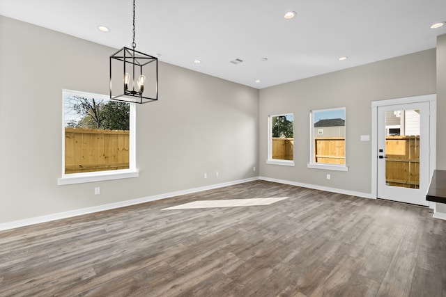 416 Stonework Landing Ln, Houston, TX 77076 - unfurnished dining area with recessed lighting, a notable chandelier, visible vents, baseboards, and wood finished floors