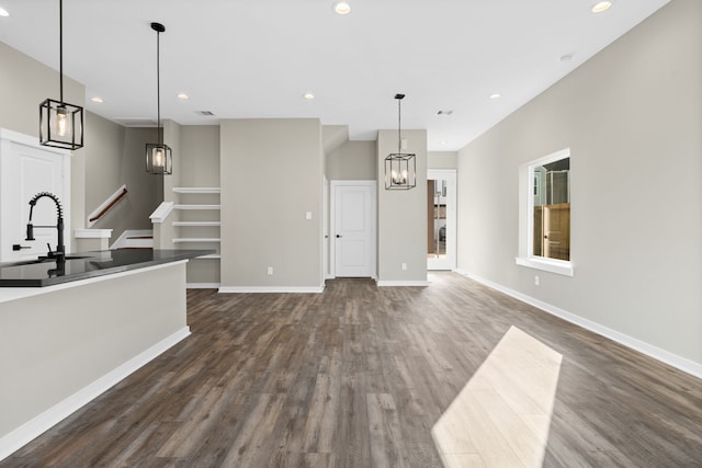 416 Stonework Landing Ln, Houston, TX 77076 - unfurnished living room with recessed lighting, a sink, dark wood-style flooring, and a chandelier