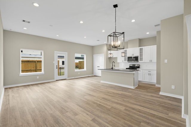 416 Stonework Landing Ln, Houston, TX 77076 - kitchen with a sink, visible vents, stainless steel appliances, a chandelier, and open floor plan