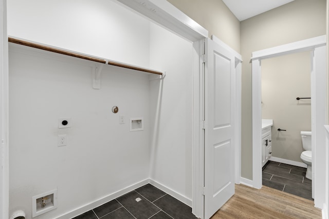 416 Stonework Landing Ln, Houston, TX 77076 - washroom with laundry area, electric dryer hookup, washer hookup, baseboards, and dark wood-style floors