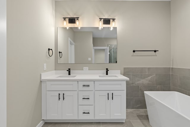 416 Stonework Landing Ln, Houston, TX 77076 - full bathroom with a freestanding tub, a shower with door, double vanity, and a sink