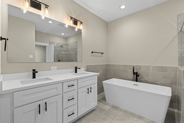 416 Stonework Landing Ln, Houston, TX 77076 - full bath with a freestanding bath, double vanity, a sink, and a shower stall