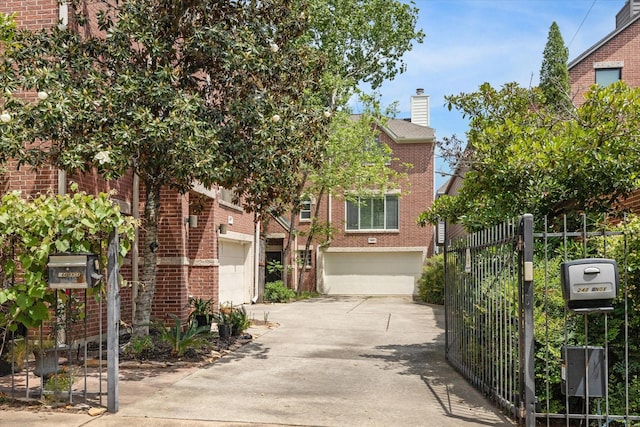 242 Knox St, Houston, TX 77007 - view of front facade featuring driveway, a chimney, fence, brick siding, and a garage