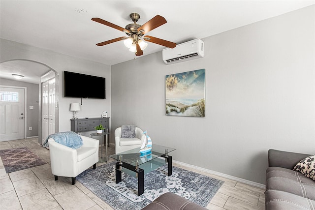 1101 Moody Ave, Galveston, TX 77550 - living area featuring baseboards, a wall mounted air conditioner, arched walkways, and a ceiling fan