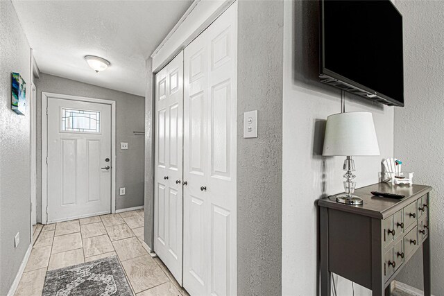 1101 Moody Ave, Galveston, TX 77550 - interior space featuring a textured ceiling, a textured wall, and baseboards
