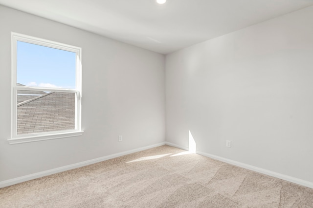 unfurnished room featuring baseboards and carpet floors