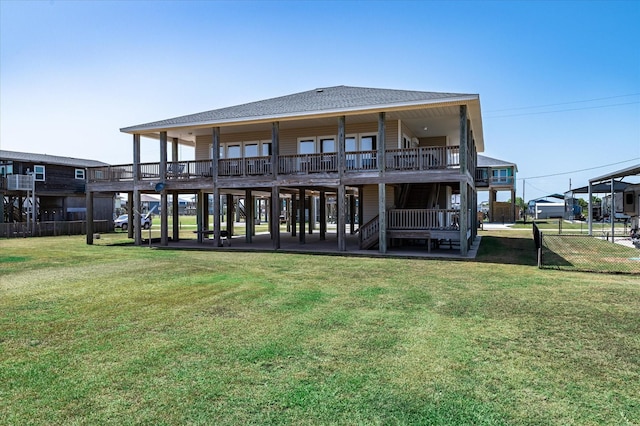 138 Verdia Dr, Crystal Beach, TX 77650 - rear view of house featuring fence, stairway, roof with shingles, and a yard