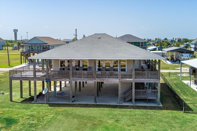 138 Verdia Dr, Crystal Beach, TX 77650 - back of house with a lawn, a deck, a patio area, and roof with shingles