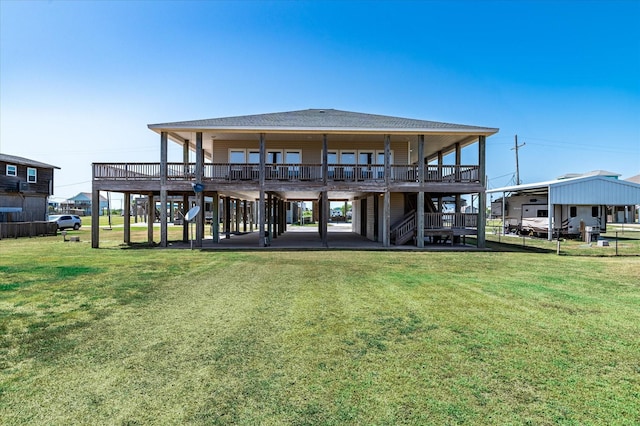 138 Verdia Dr, Crystal Beach, TX 77650 - back of property with a lawn, a shingled roof, and stairs