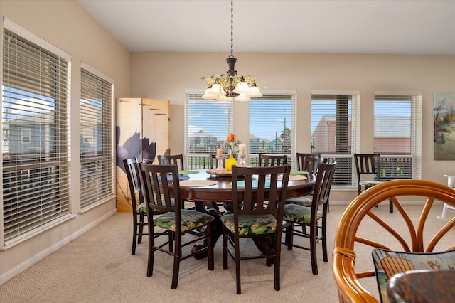 138 Verdia Dr, Crystal Beach, TX 77650 - dining area featuring a notable chandelier, baseboards, light carpet, and plenty of natural light