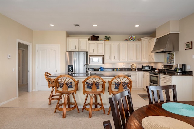 138 Verdia Dr, Crystal Beach, TX 77650 - kitchen featuring a sink, dark countertops, stainless steel appliances, wall chimney exhaust hood, and a kitchen island with sink