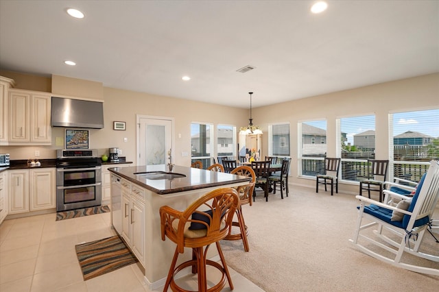 138 Verdia Dr, Crystal Beach, TX 77650 - kitchen featuring recessed lighting, white dishwasher, a sink, range with two ovens, and wall chimney exhaust hood