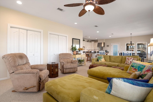 138 Verdia Dr, Crystal Beach, TX 77650 - living room featuring recessed lighting, visible vents, light colored carpet, and ceiling fan with notable chandelier