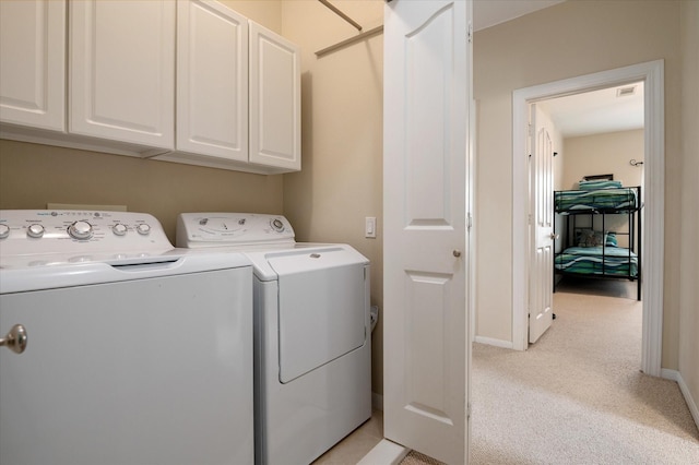 138 Verdia Dr, Crystal Beach, TX 77650 - washroom with washing machine and clothes dryer, cabinet space, baseboards, and light carpet