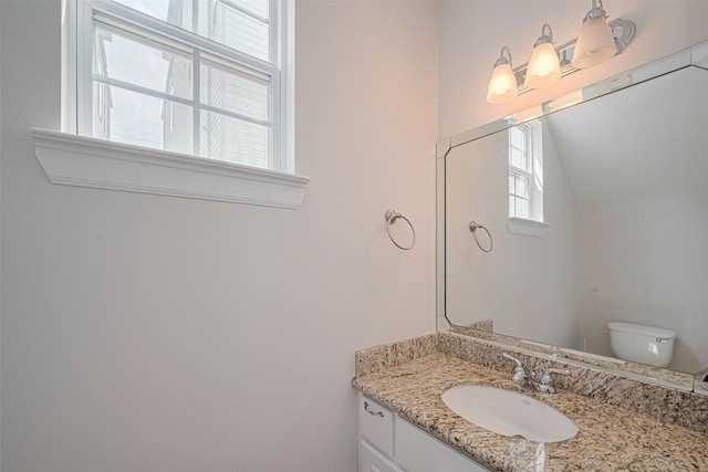 bathroom featuring toilet and vanity