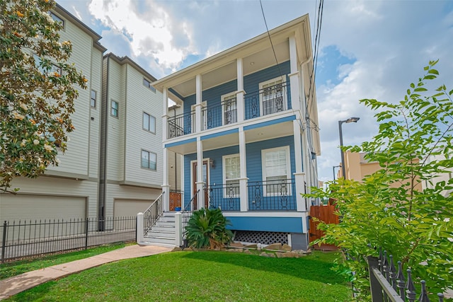 view of front of house with a porch, fence, a garage, a front lawn, and a balcony