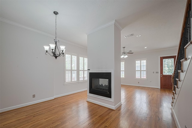 unfurnished living room featuring stairway, visible vents, light wood-style floors, baseboards, and ornamental molding