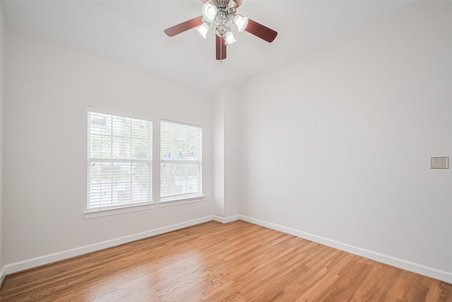 empty room featuring baseboards, light wood-style flooring, ceiling fan, and lofted ceiling